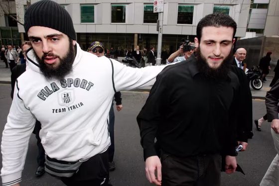 Image: Raad leaves a Melbourne court with an unidentified man after being found not guilty of being a member of a terrorist organisation